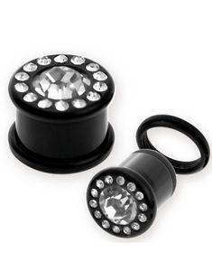 Svart Piercing Plugg med En Klar Sten Ramad in av Små